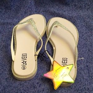 Sliver and white flip flops